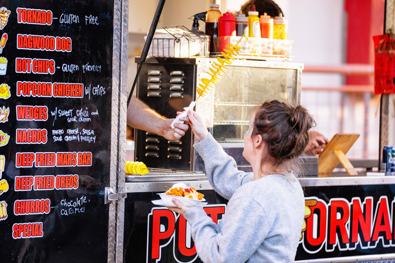 Woman purchasing food from a stall
