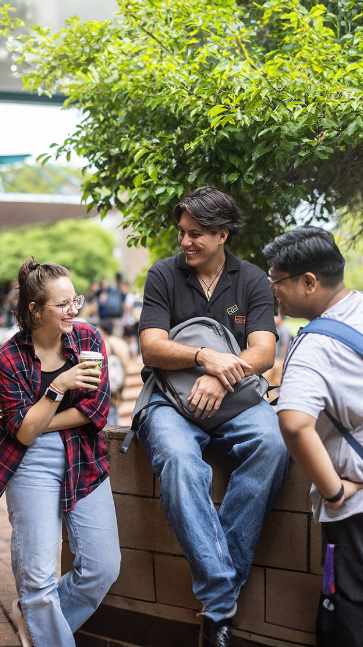 group of three on a wall at orientation