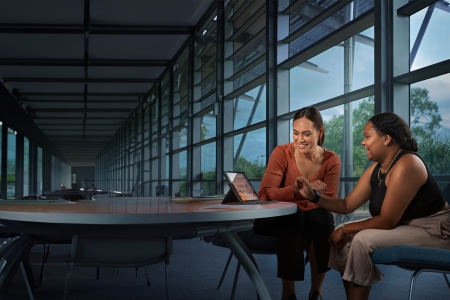students sitting around a laptop