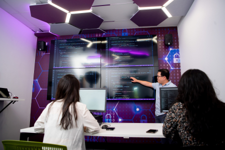 students review coding on large screen
