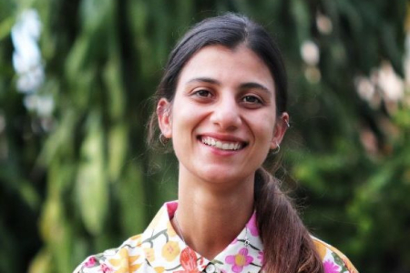 Sonu Yadav, head and shoulders, wearing a flowery shirt, with out of focus greenery in the background