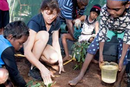 From left: Jon Jon Singh, CDU Horticulture lecturer Emily Hinds, assistant teacher Ses Zaro, Liam Woodie and Alithia Jorrock plant aibika in a freshly prepared veggie patch at Belyuen School. Photo: Julianne Osborne