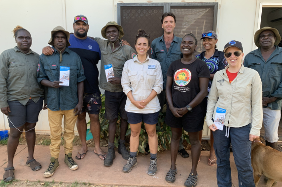 group of rangers and researchers standing outside a building