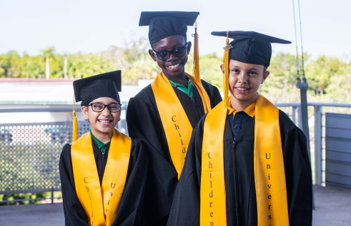 Jasnam Kaur, Daniel Mbemap and Latoya Djumadi celebrate learning at graduation