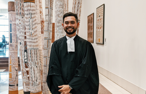 CDU student Max Stretton smiling in his graduation robes