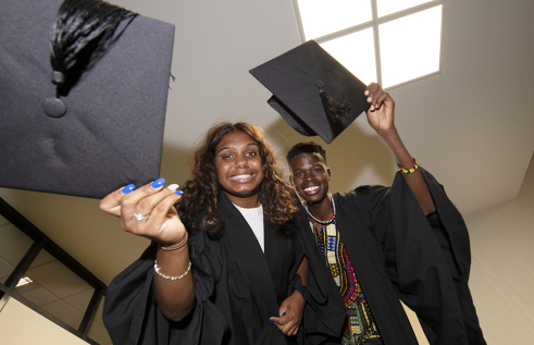 Students Nancy Holtze and Makuer Akol celebrate graduating from the Team Aspire program