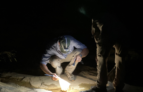 researcher sampling ground water