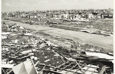Black and white photo of destroyed houses after Cyclone Tracy hit a suburb of Darwin.